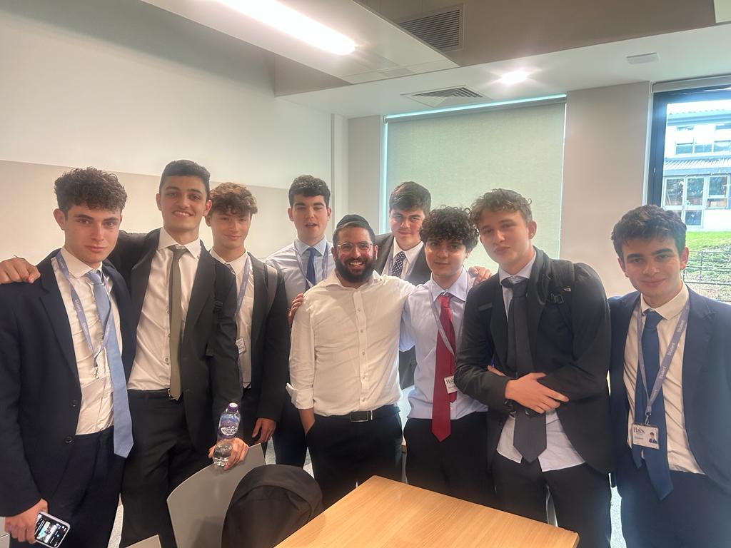 Rabbi Aidyn with students in school uniforms