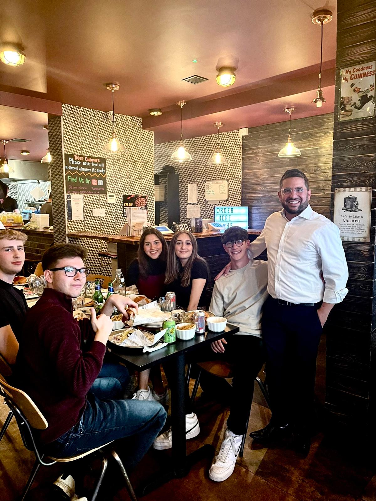 Rabbi Aidyn with students at a restaurant